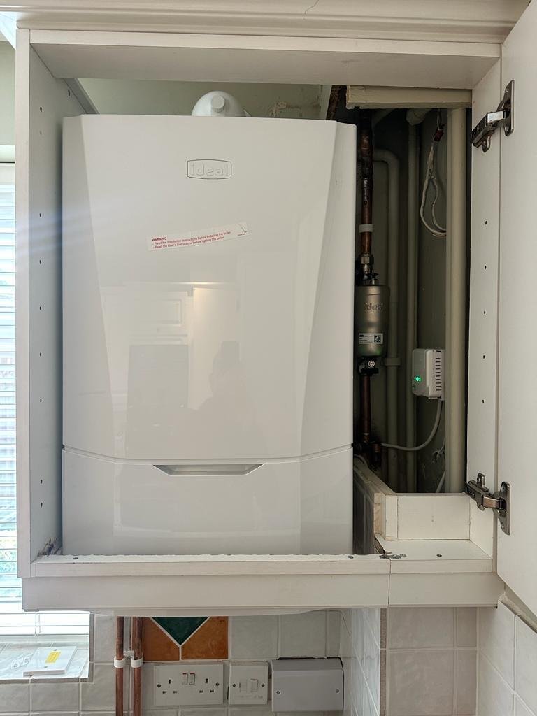New Ideal combi boiler installed inside a kitchen wall unit in Northamptonshire