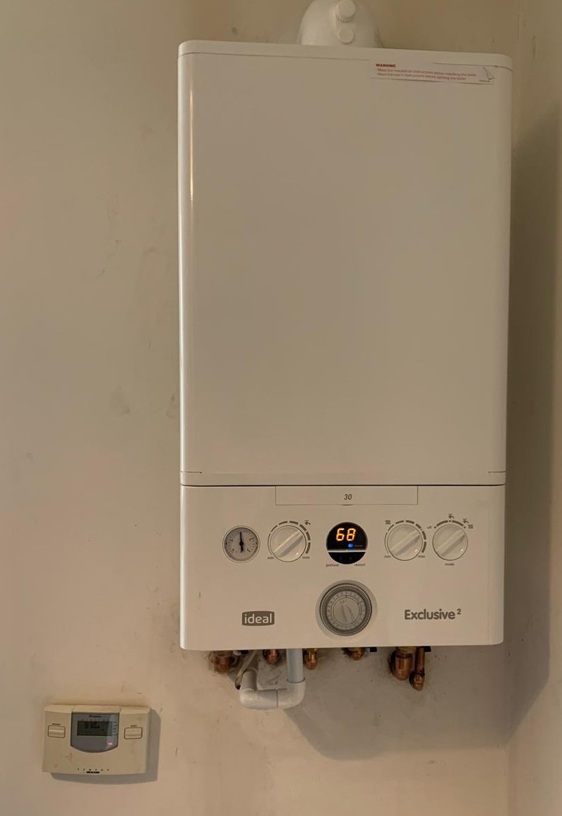 Ideal Exclusive combi boiler on a domestic wall, repaired by a Gas Safe engineer in Northamptonshire