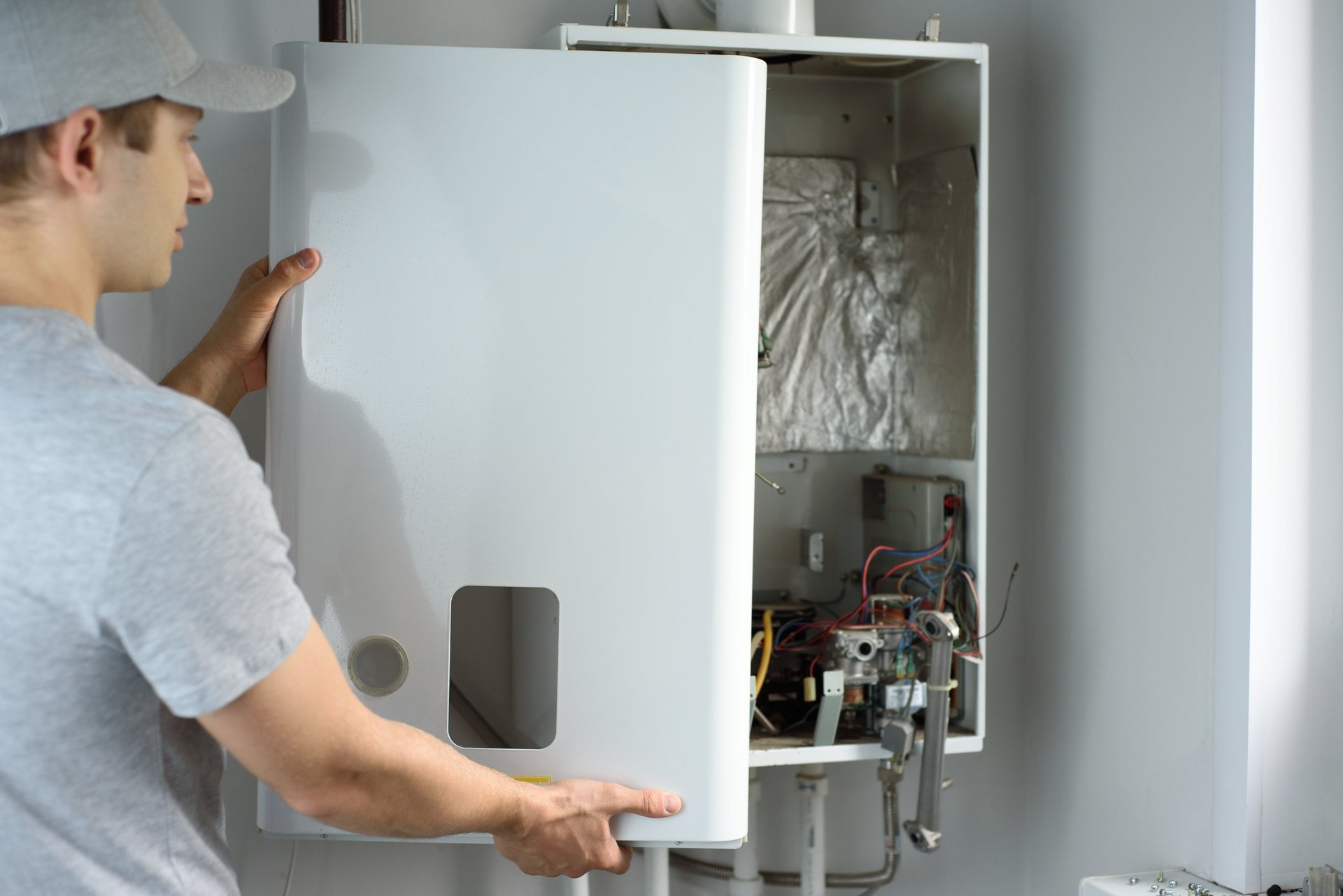 Gas engineer checking boiler for home heating maintenance