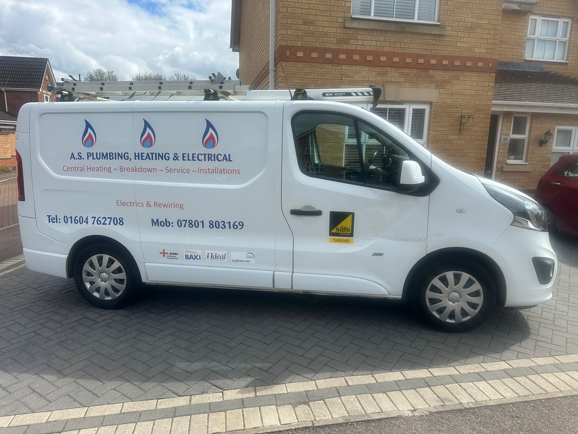 White A.S. Plumbing, Heating & Electrical service van parked on brick driveway in front of brick residential building